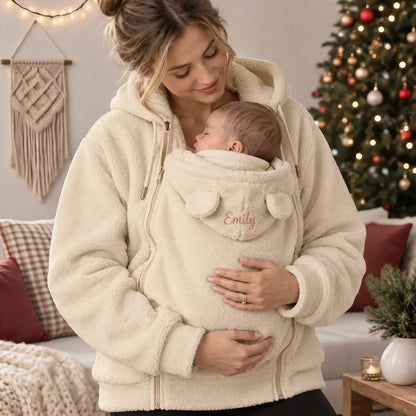 Personalized Embroidered Fleece Babywearing Hoodie, Mom Cuddling Baby in a Christmas Living Room, Unique Gift
