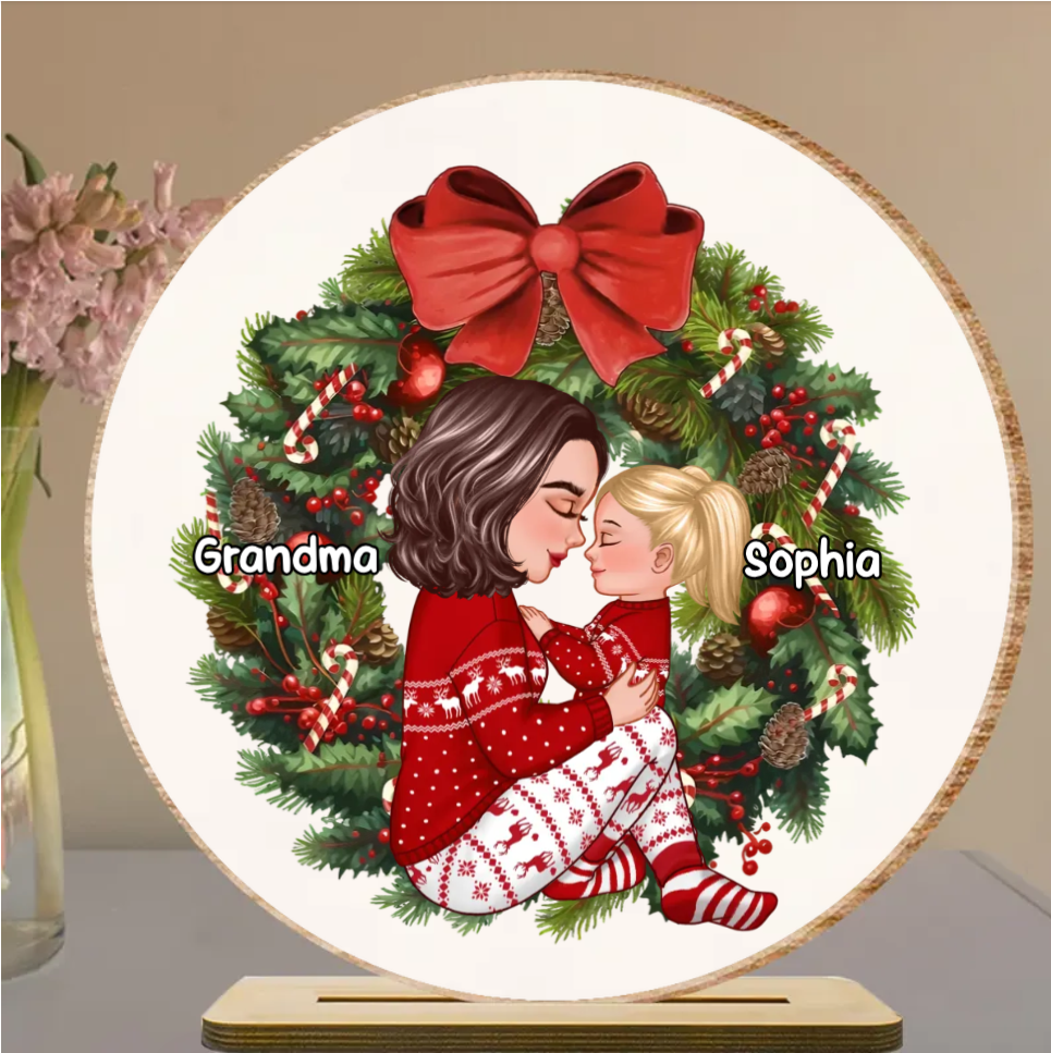 Grandma Mom Hugging Kid Sitting On Christmas Wreath Personalized Piggy Bank or Ornament or Plaque or Keychain or Poster